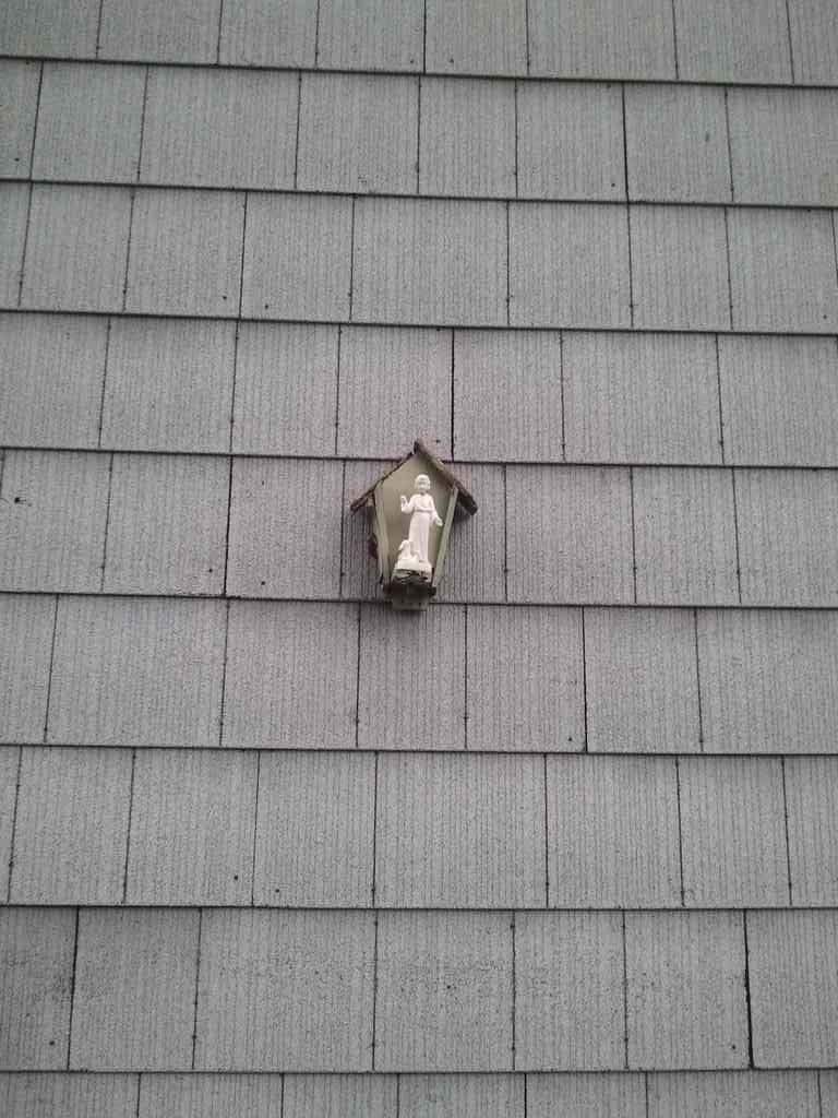 Oh my! The 'light fixture' on the back of the house is really a statue!