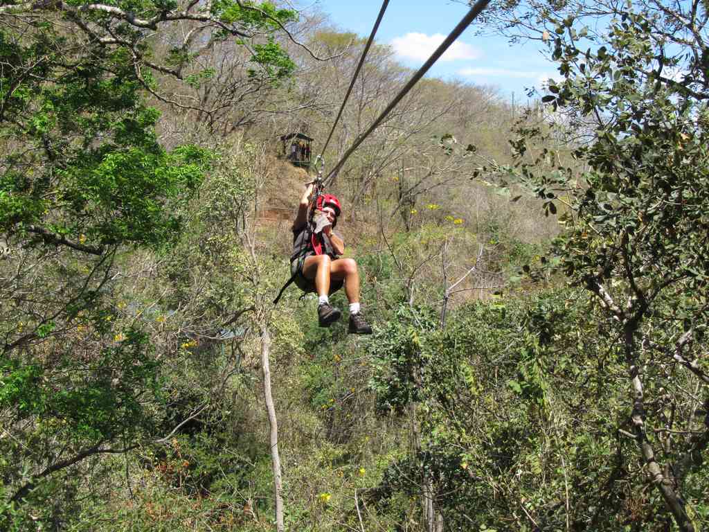 Jeff flying through the middle of a massive zip line run!