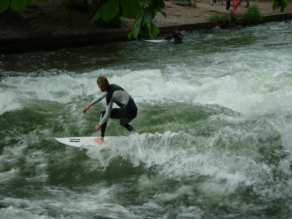 The Isar river is funneled under a bridge to create a continuous, standing wave. Locals surf it year-round, and there is always a long line waiting for a turn!