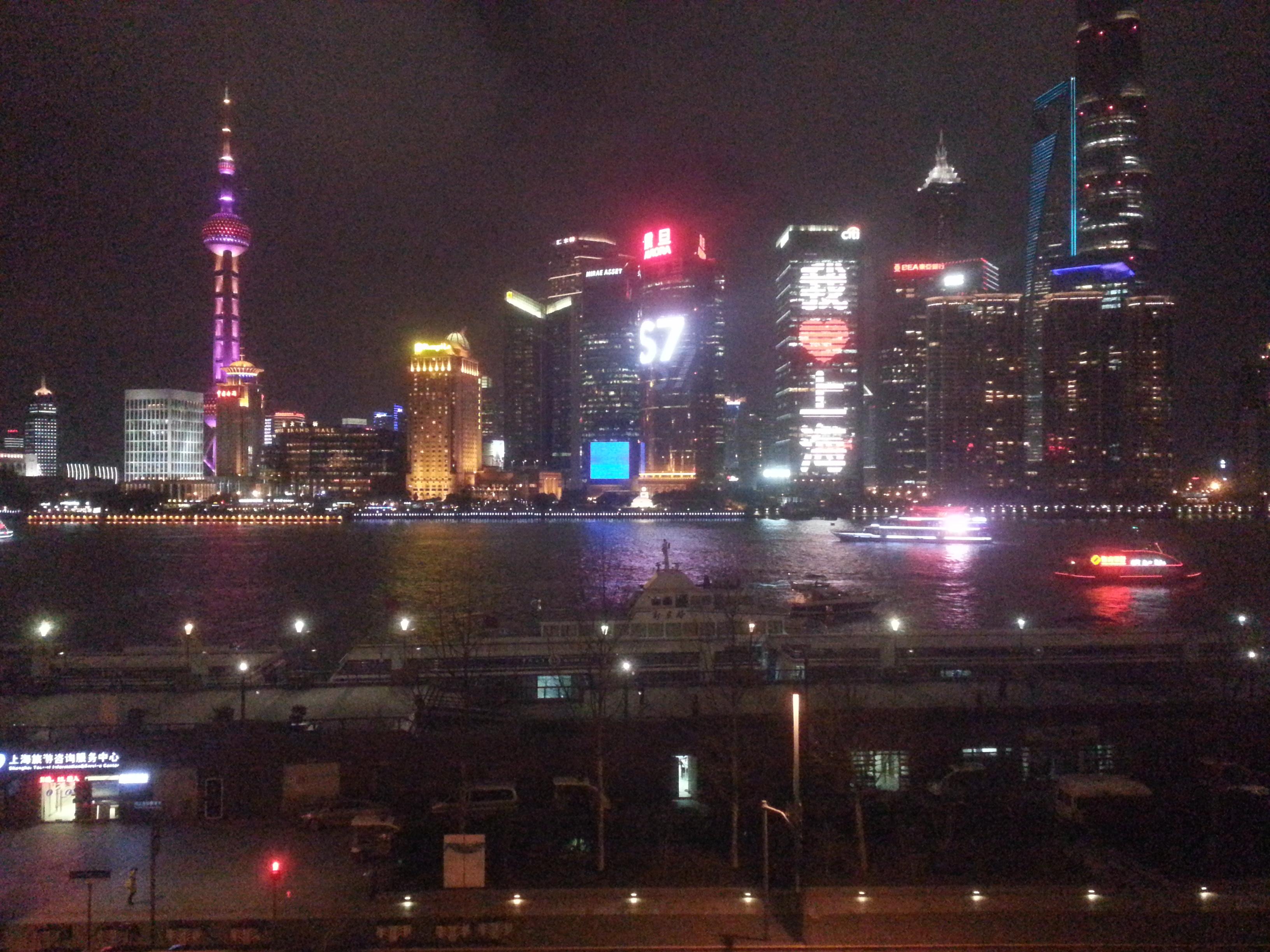 The illuminated Pearl Tower is on the left. The building just to the right of the center was completely covered in changing, animated LED lights serving as a massive, skyscraper-sized billboard!