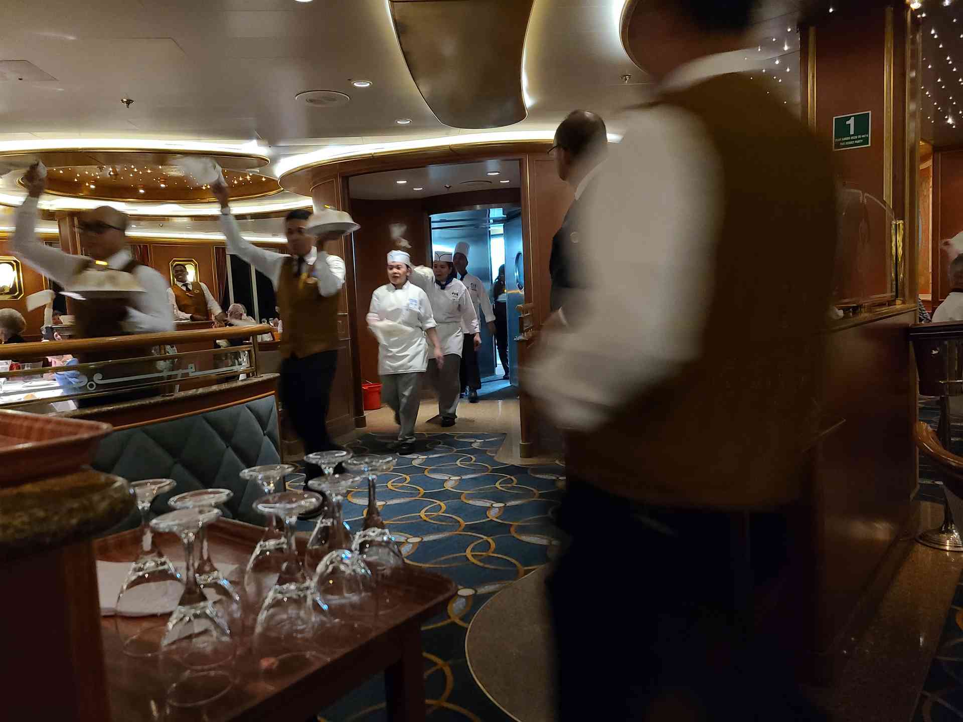 The final dinner tradition! The kitchen staff parades through the dining room with a massive Baked Alaska while everyone cheers to show their appreciation.