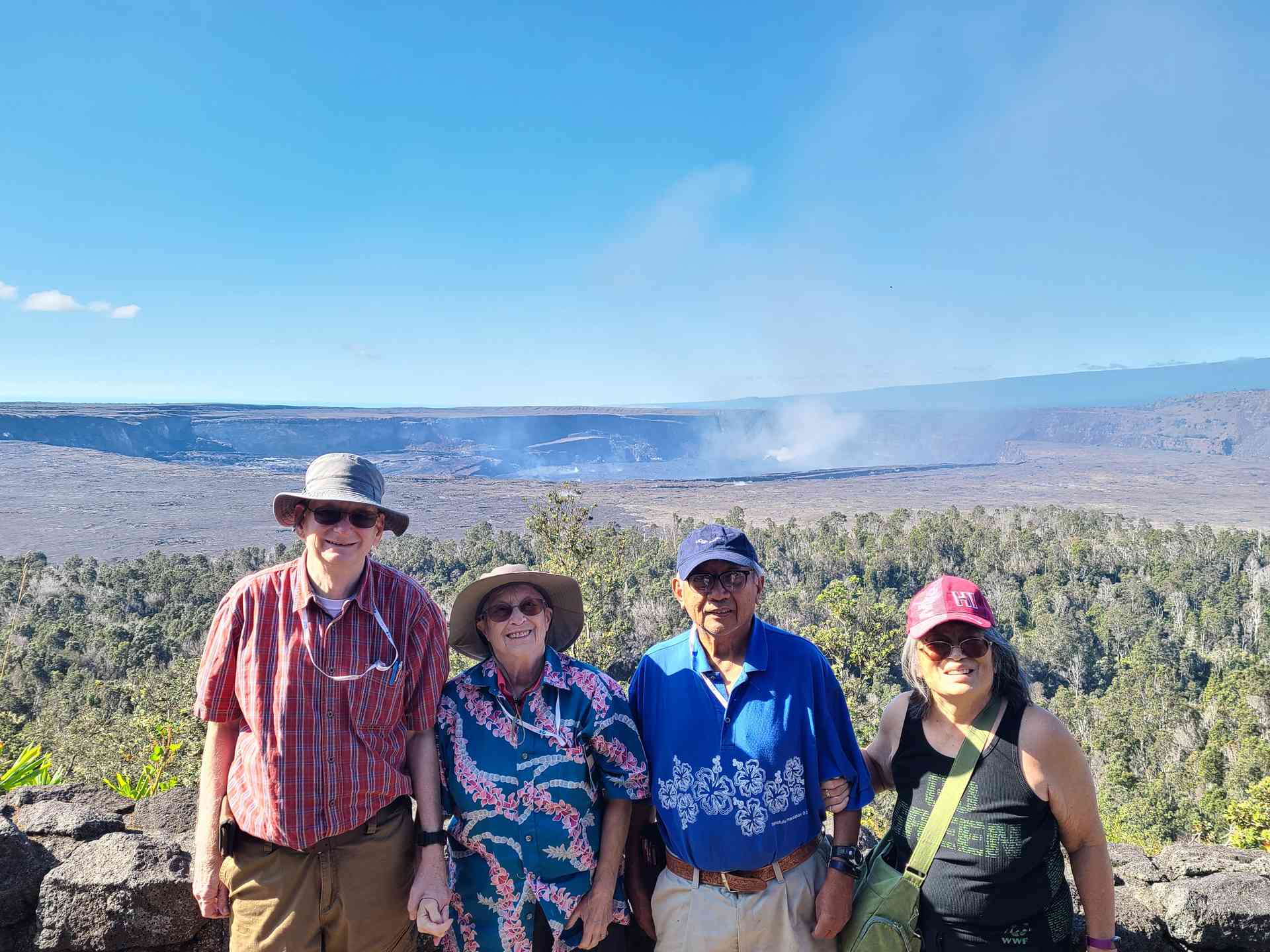 Charles, Helen, Vic, and Doris at an overlook. The volcano is still venting sulfur dioxide and other gases in the background.