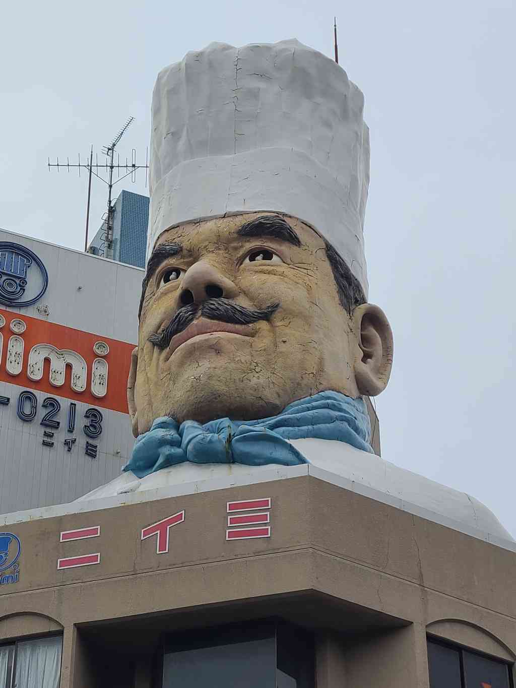This massive, iconic chef's head sits proudly on top of a building, welcoming everyone to Kitchen Town!